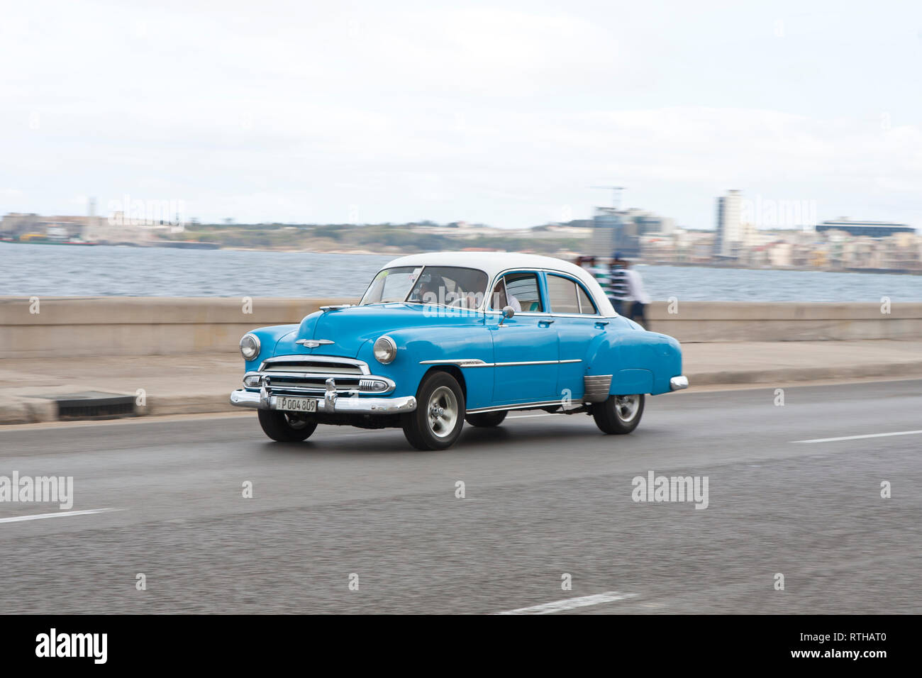 Classic 1950's American car road trip driving along the Malecon in Havana Cuba Stock Photo