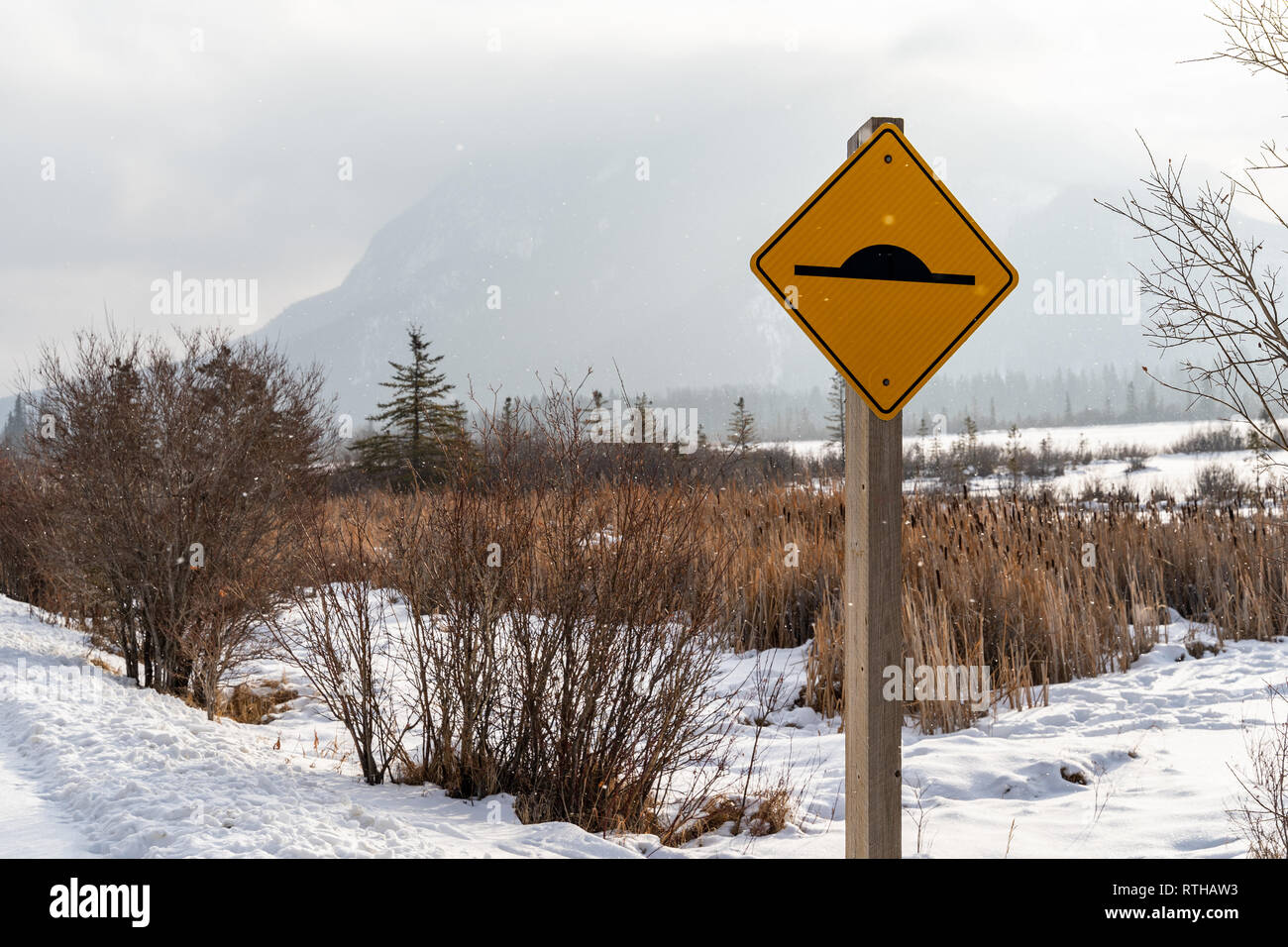 Sign warning drivers of a speed bump ahead. Photo taken in Banff