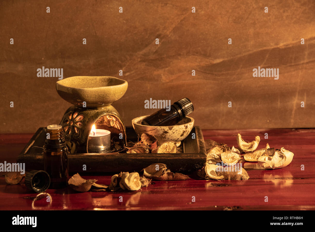 Aroma lamp with essential oil and potpourri on wooden table background. Stock Photo