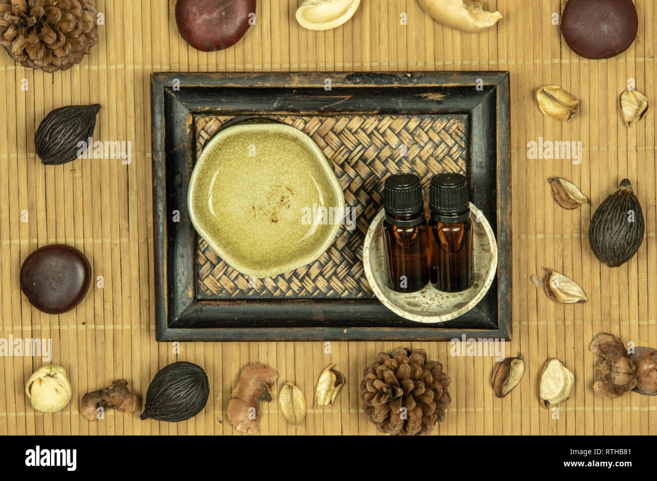 Aroma lamp with essential oil and potpourri on wooden bamboo mat background. Stock Photo