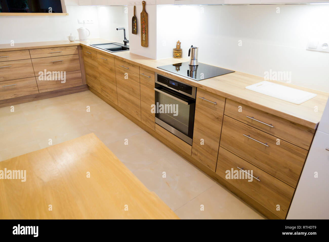 Aesthetic modern narrow kitchen with wooden furnitures Stock Photo Alamy