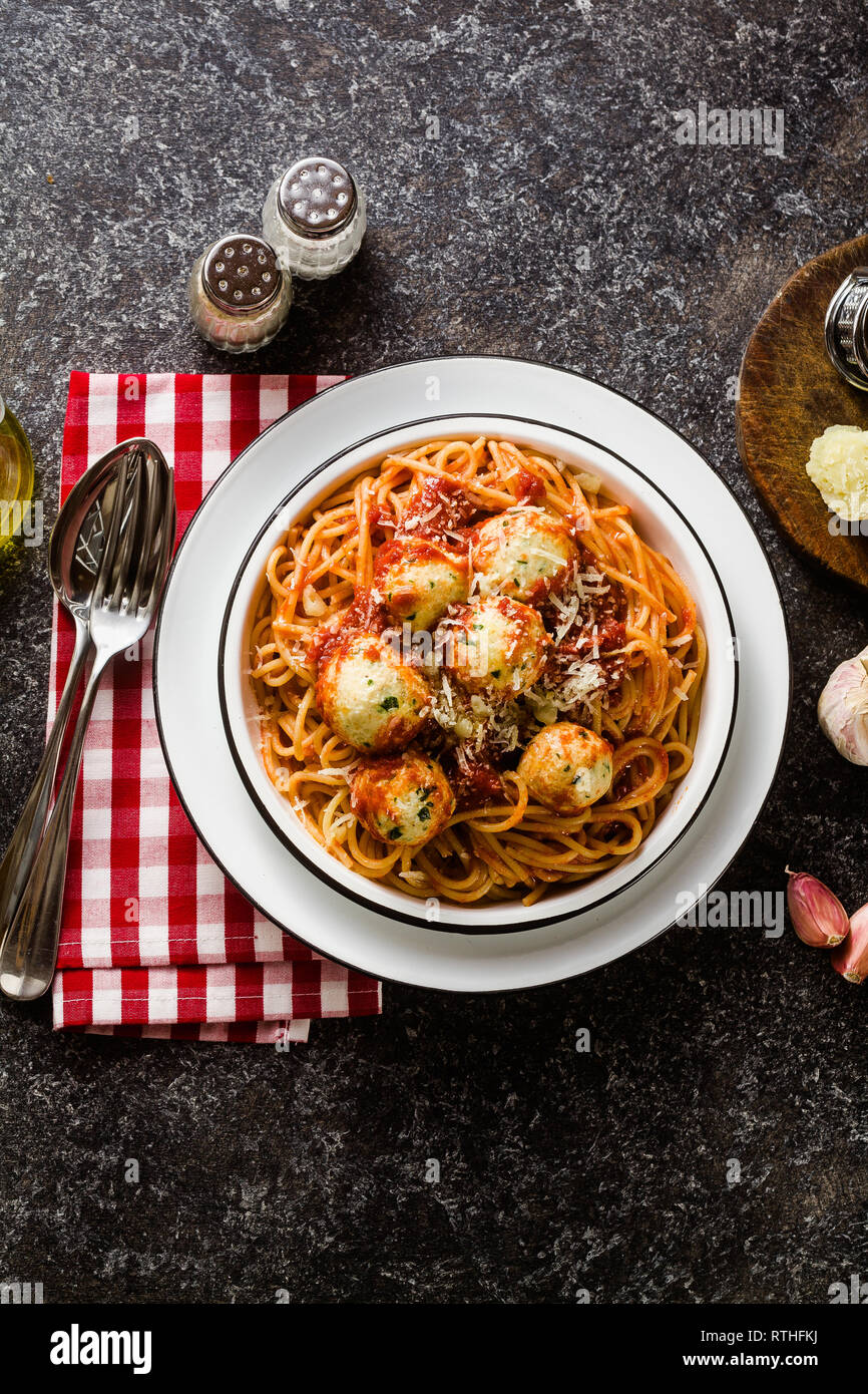 Italian pasta spaghetti with ricotta cheese balls in tomato sauce on