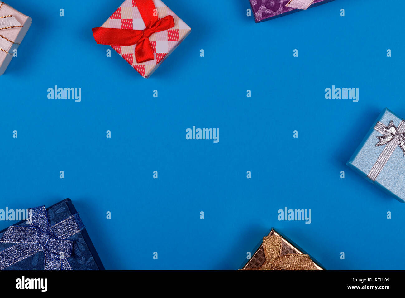 Blue background with colorful gift boxes Stock Photo - Alamy
