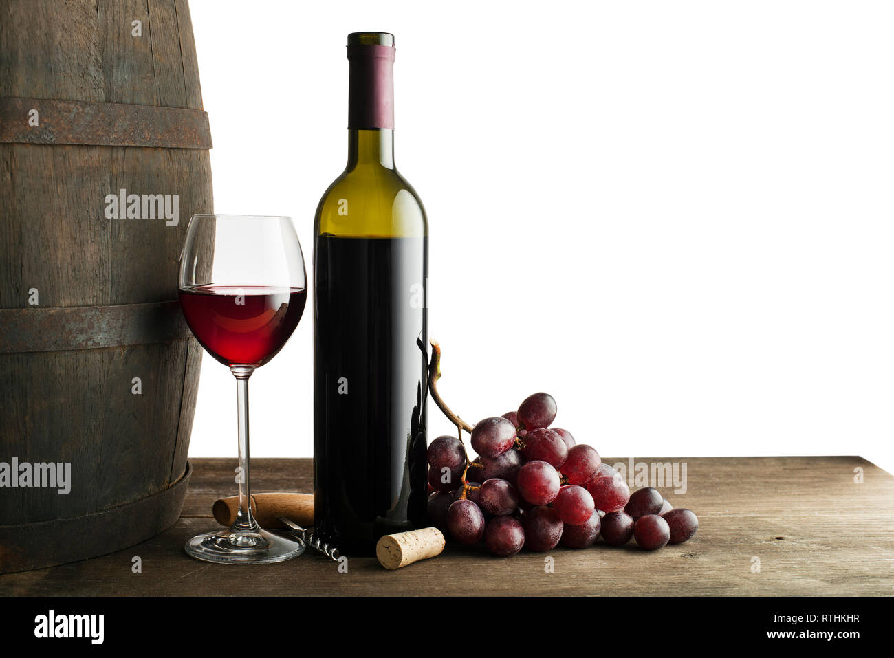 Glass and bottle of red wine with wooden and barrel background isolated ...