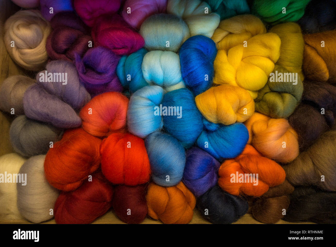 Craft drawer full of brightly coloured merino wool tops for needle felting Stock Photo