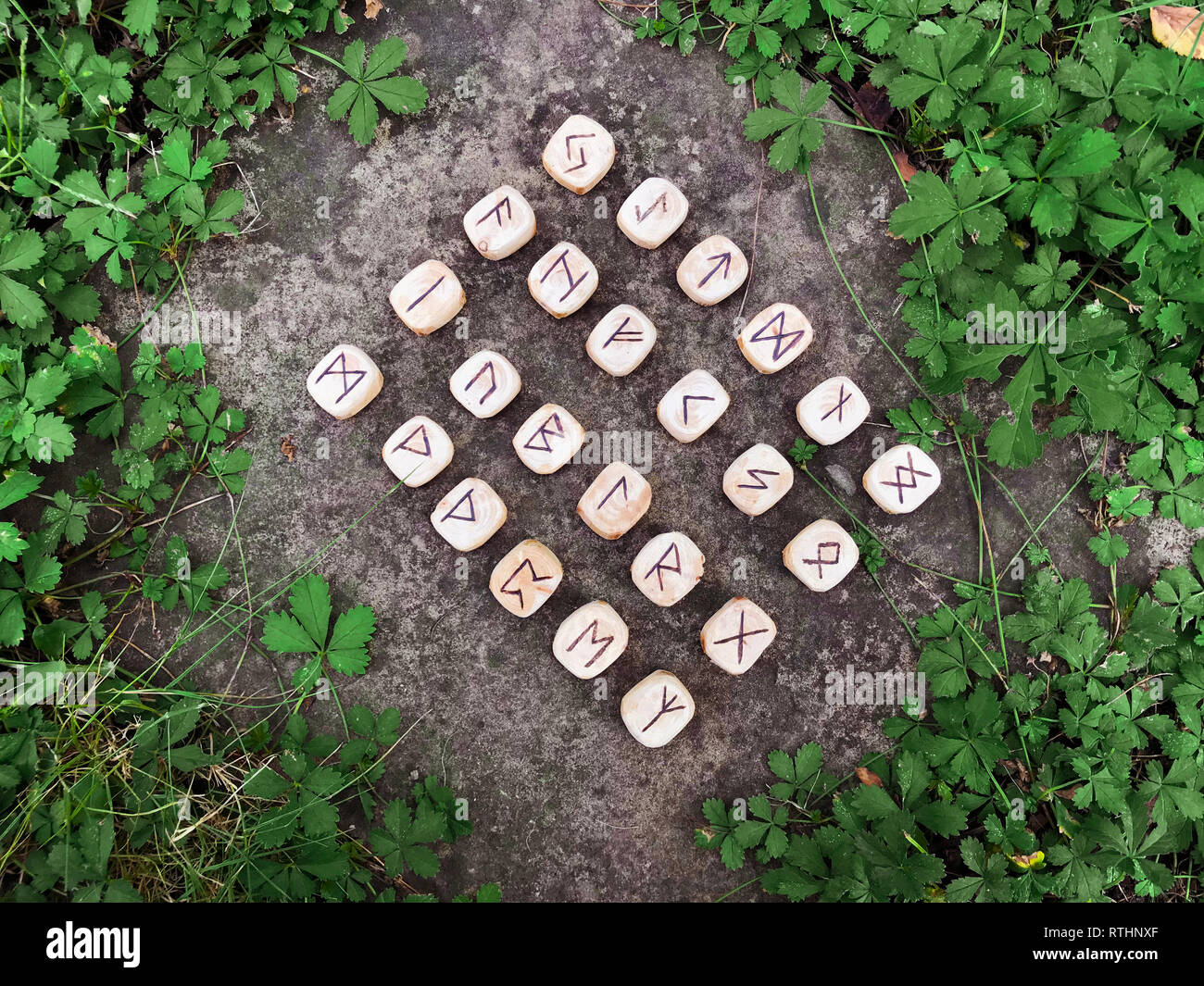 A stack of wooden runes at forest. Wooden runes lie on a rock