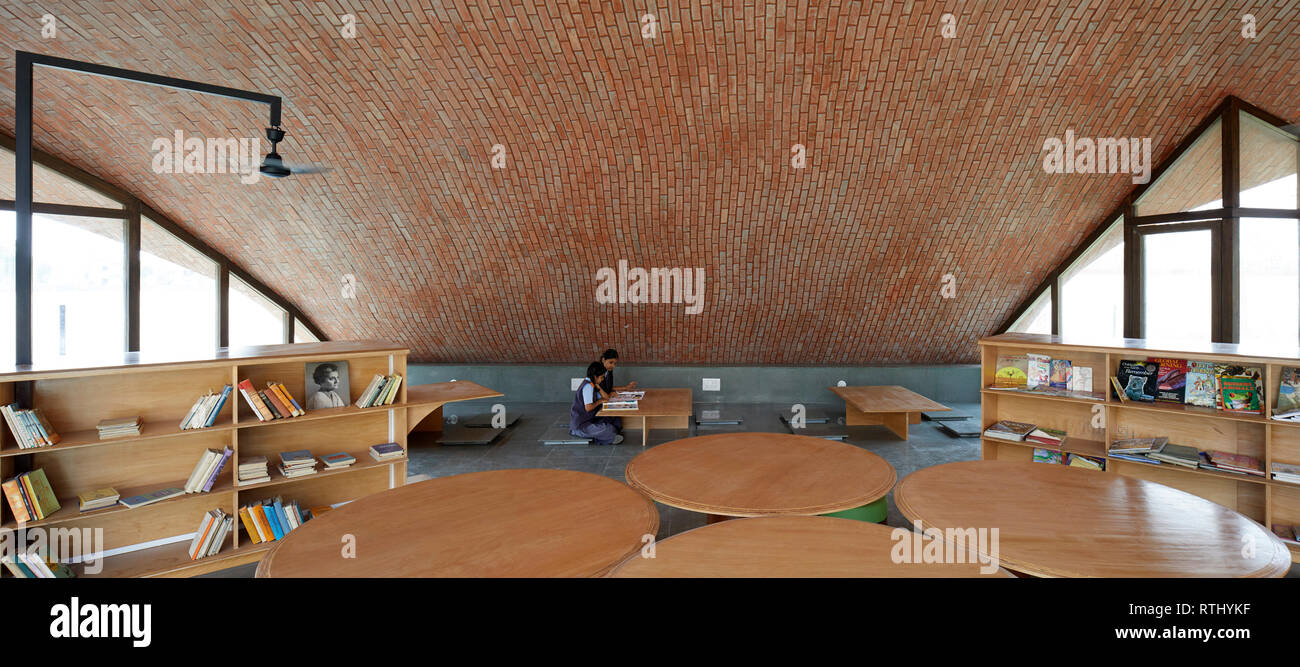 Interior view with students at work. Maya Somaiya Library, Kopargaon/Maharashtra, India. Architect: Sameep Padora and associates (SP+A), 2018. Stock Photo