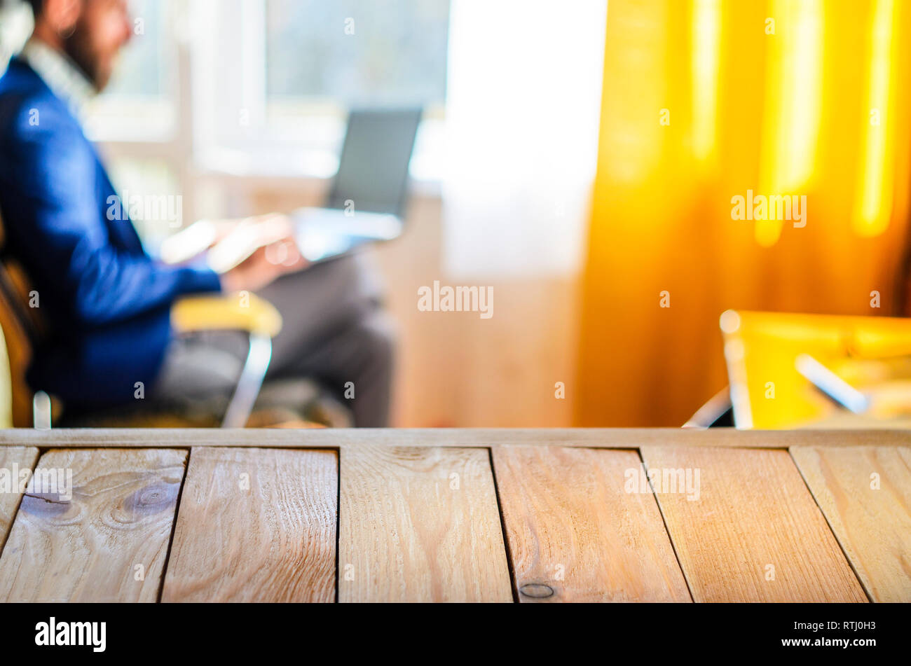 Wooden Table Top Against Blurry Interior Background A