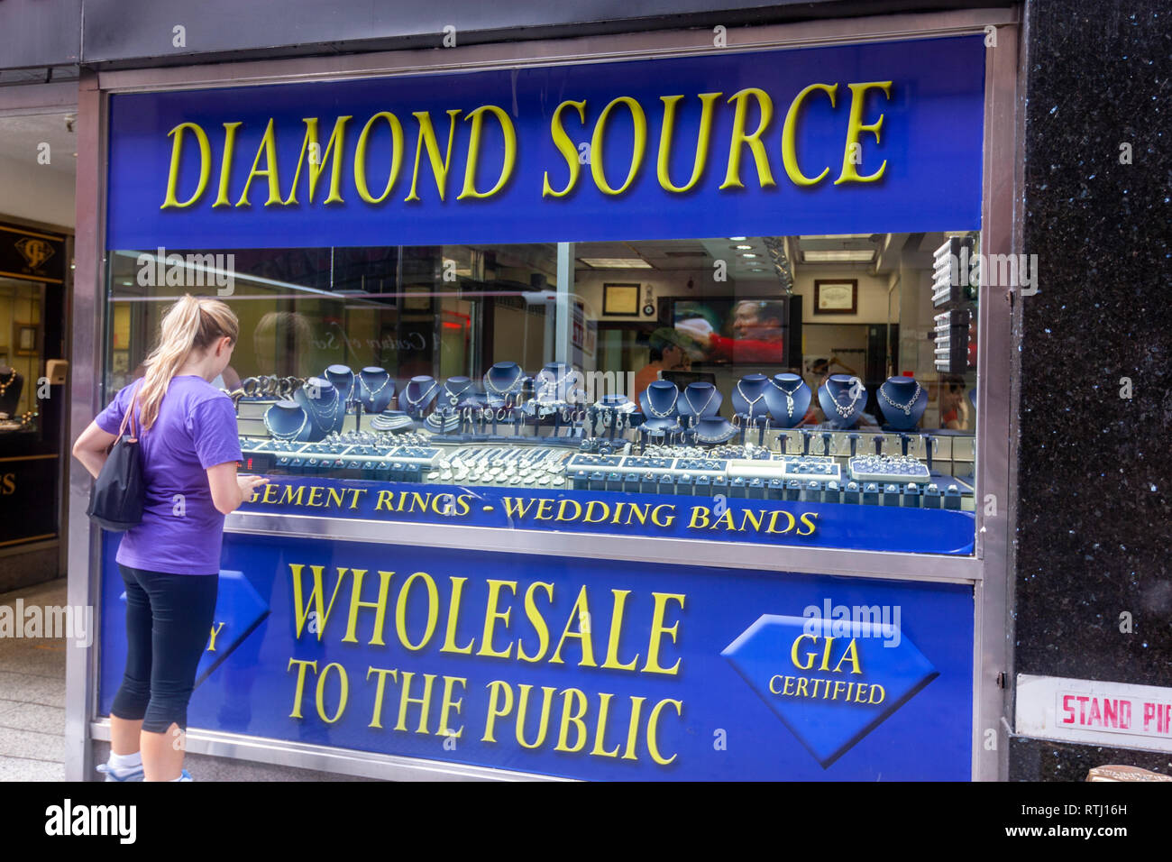 Woman looking a Diamond shop window display in  29 W 47th St, Manhattan, New York, USA Stock Photo