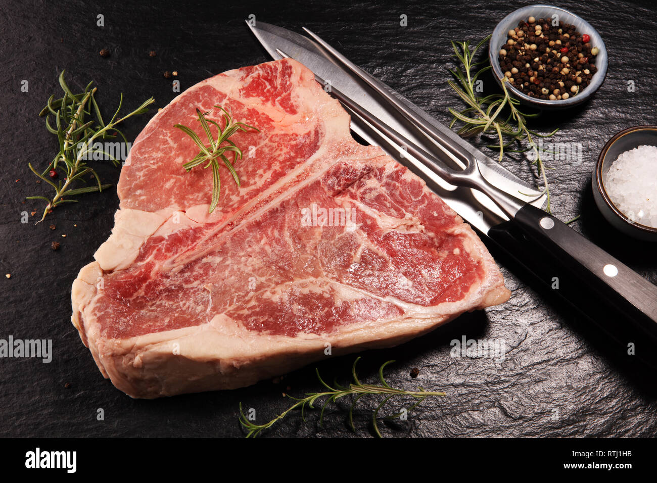 Raw Tbone steak on stone plate. bbq bone steak set Stock Photo Alamy