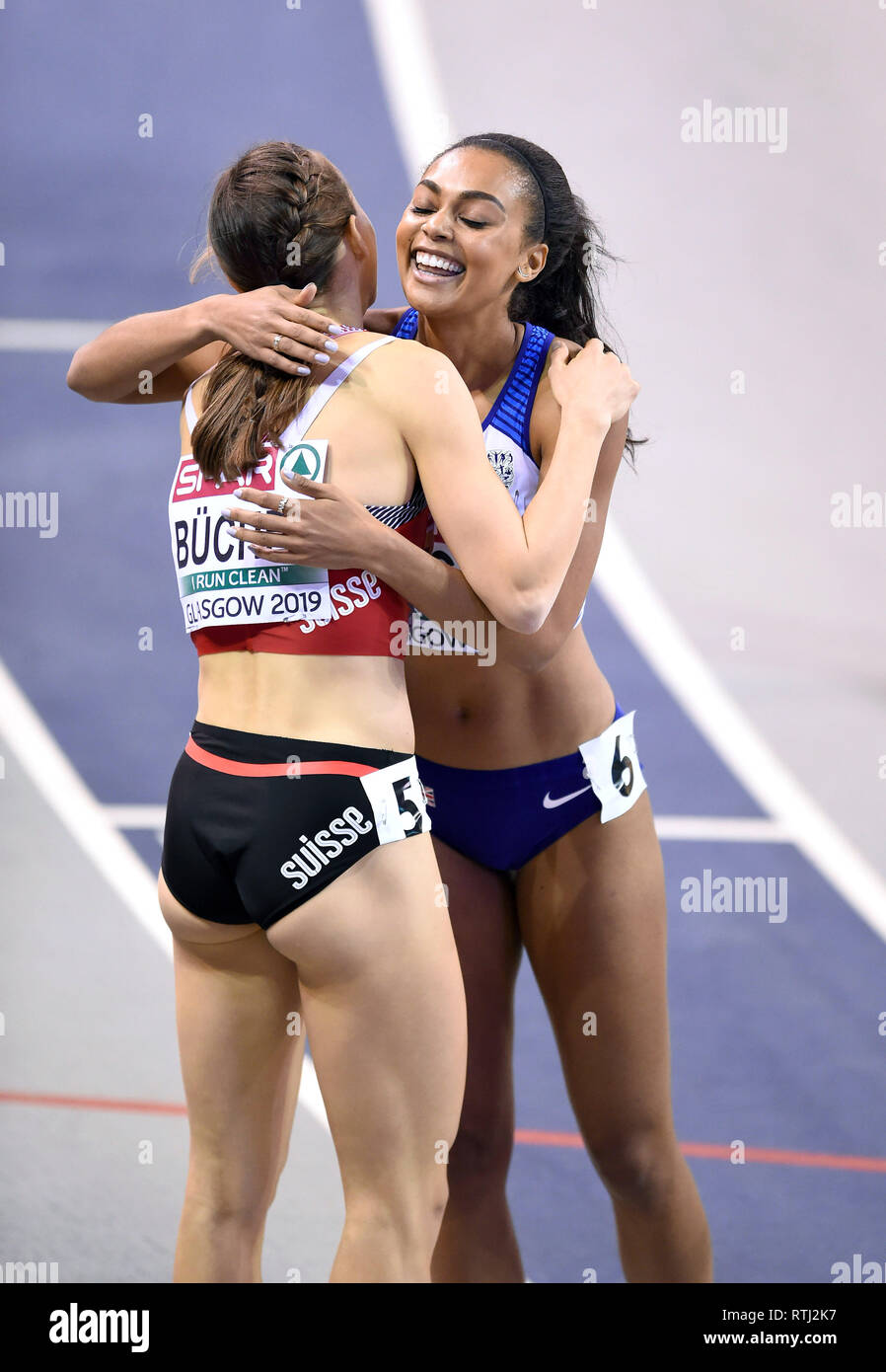Great Britains Adelle Tracey (6) hugs Switzerland's Selina Buchel after the finish of their 800m heat during day one of the European Indoor Athletics Championships at the Emirates Arena, Glasgow. Stock Photo