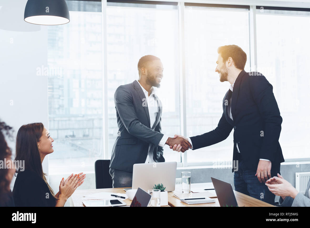 Welcome on board. Men shaking hands at office Stock Photo