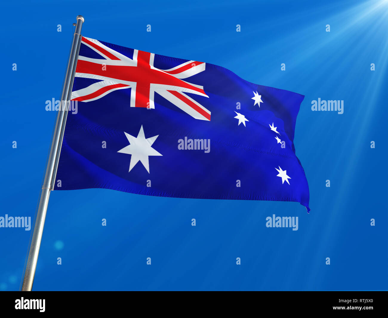 Australia National Flag Waving on pole against deep blue sky background