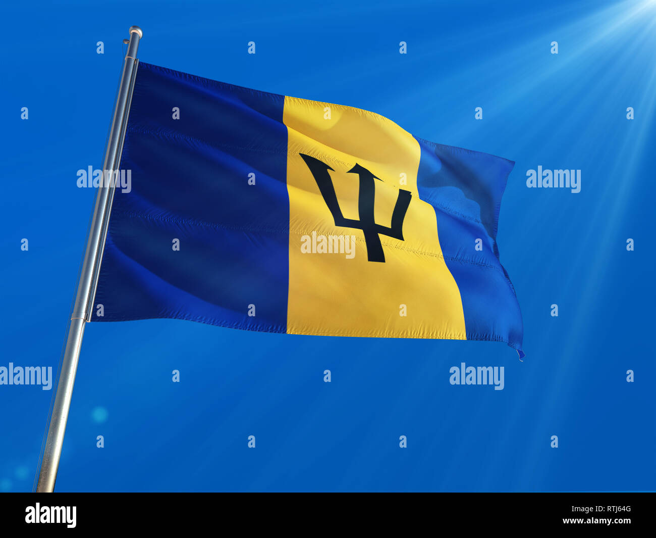 Barbados National Flag Waving on pole against deep blue sky background