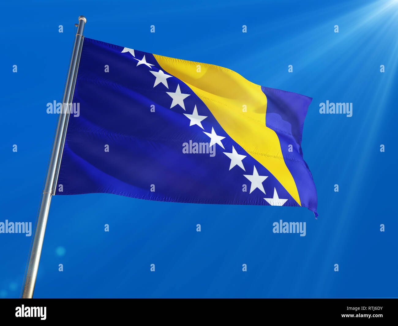 Bosnia Herzegovina National Flag Waving on pole against deep blue sky ...