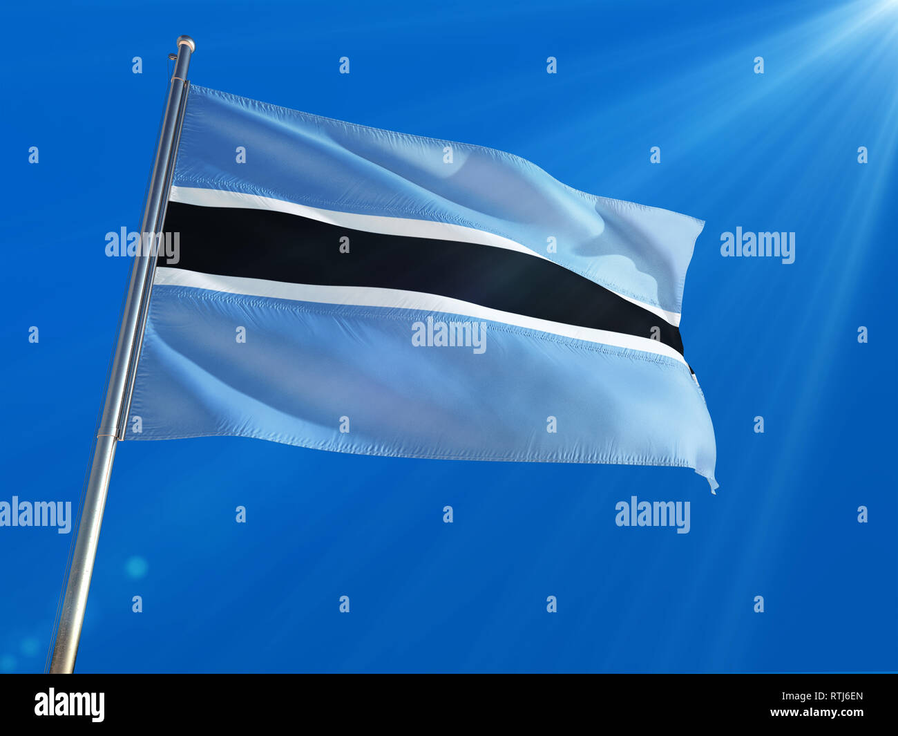 Botswana National Flag Waving On Pole Against Deep Blue Sky