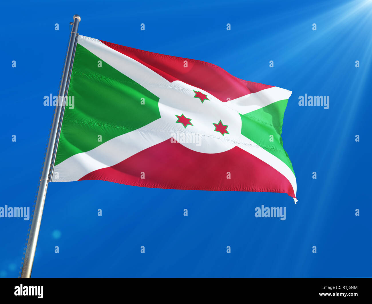 Burundi National Flag Waving on pole against deep blue sky background ...