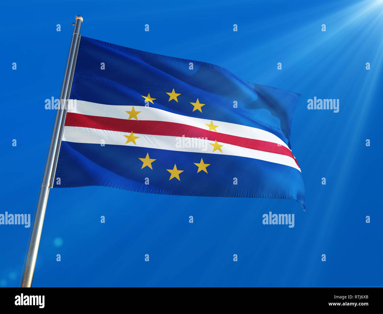 Cape Verde National Flag Waving on pole against deep blue sky background. High Definition Stock Photo