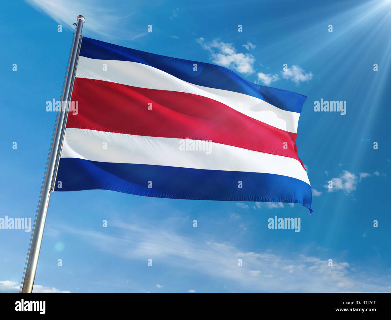 Costa Rica National Flag Waving on pole against sunny blue sky background. High Definition Stock