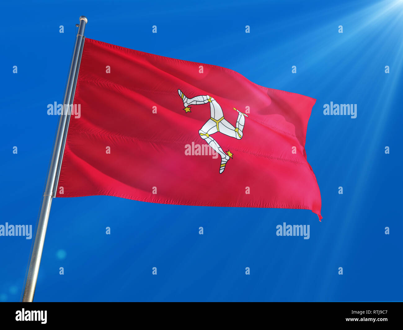 Isle Of Man National Flag Waving on pole against deep blue sky