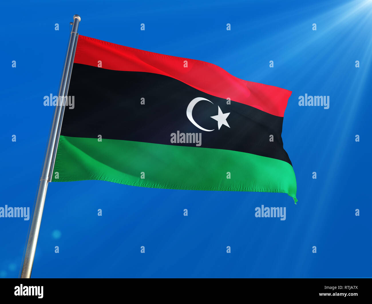 Libya National Flag Waving On Pole Against Deep Blue Sky