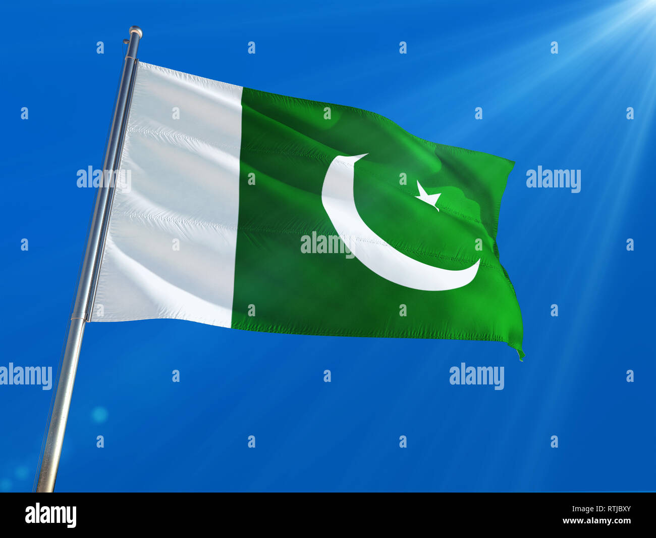 Pakistan National Flag Waving On Pole Against Deep Blue Sky