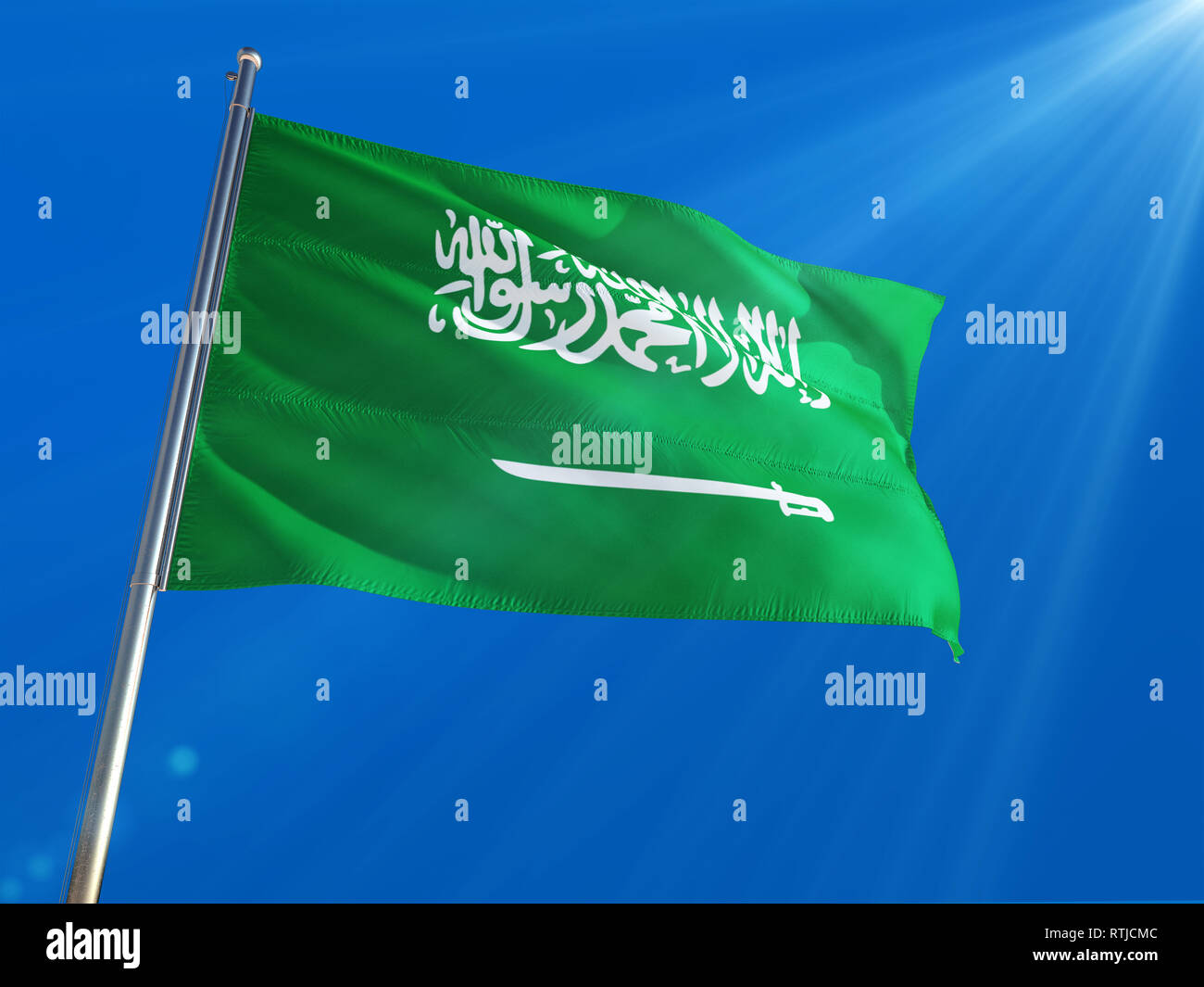 Saudi Arabia National Flag Waving On Pole Against Deep Blue Sky