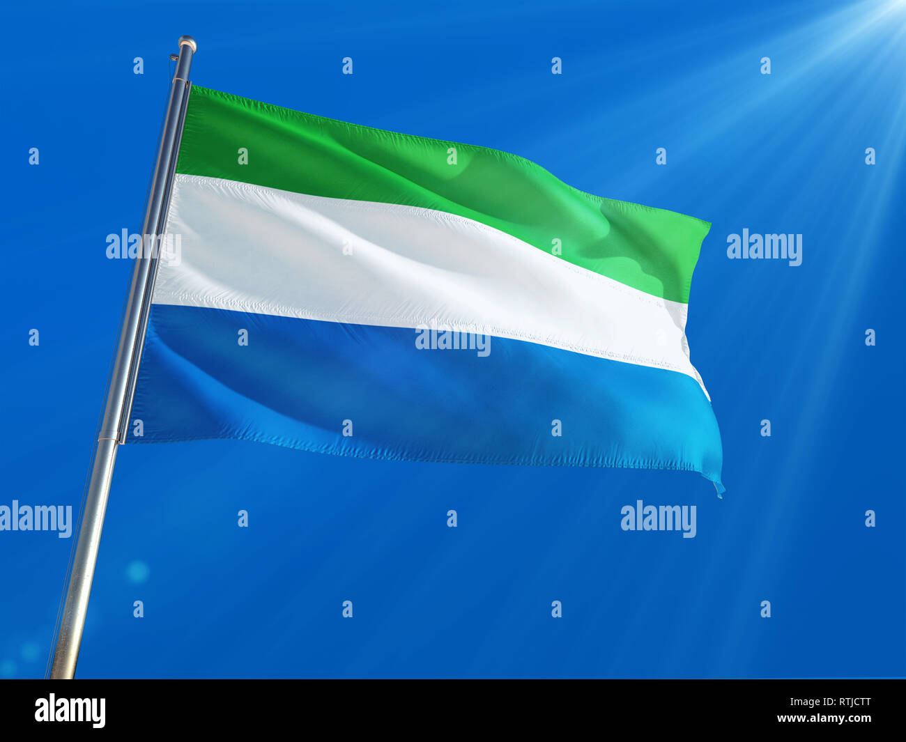 Sierra Leone National Flag Waving on pole against deep blue sky ...