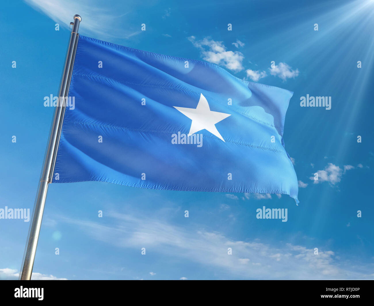 Somalia National Flag Waving on pole against sunny blue sky background