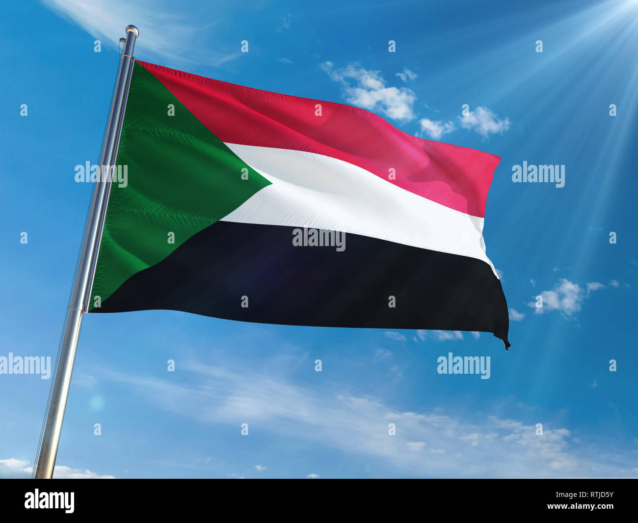 Sudan National Flag Waving on pole against sunny blue sky background ...