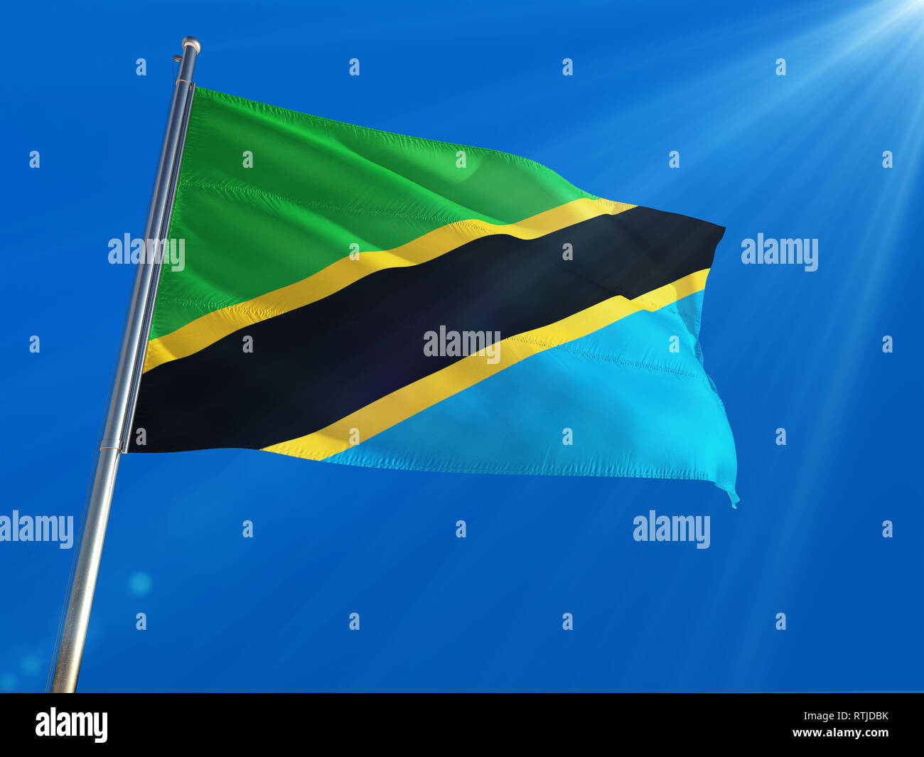 Tanzania National Flag Waving on pole against deep blue sky background ...