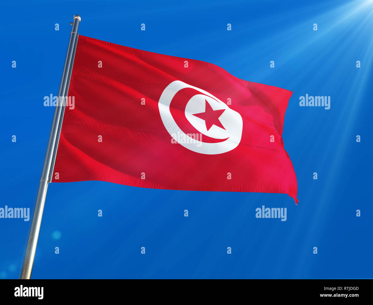 Tunisia National Flag Waving On Pole Against Deep Blue Sky