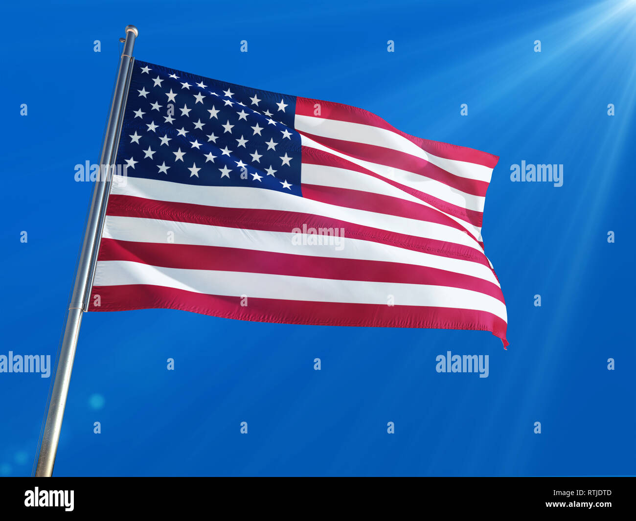 United States National Flag Waving on pole against deep blue sky ...