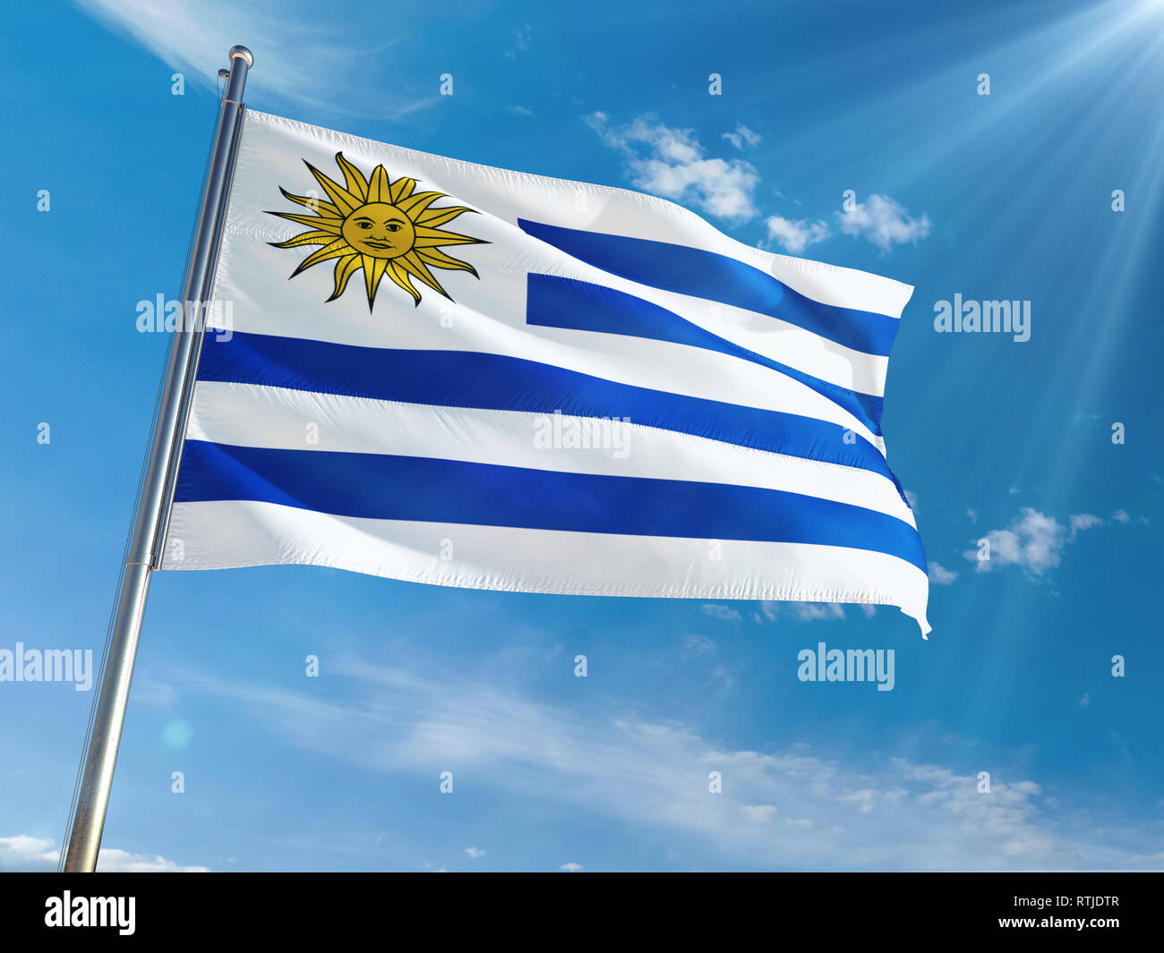 Uruguay National Flag Waving On Pole Against Sunny Blue Sky Background High Definition Stock Photo Alamy