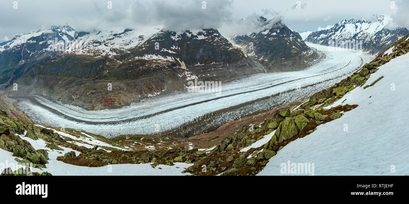Great Aletsch Glacier and ice fall summer cloudy panorama  (Bettmerhorn, Switzerland, Alps mountains) Stock Photo