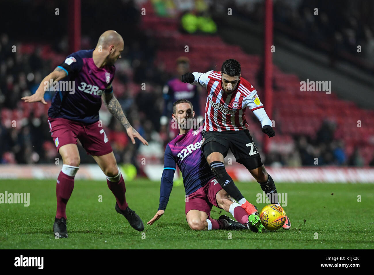 13th February 2019, Griffin Park, London, England; Sky Bet Championship, Brentford vs Aston Villa ; Saïd Benrahma (21) of Brentford is slide tackled  Credit: Phil Westlake/News Images,  English Football League images are subject to DataCo Licence Stock Photo