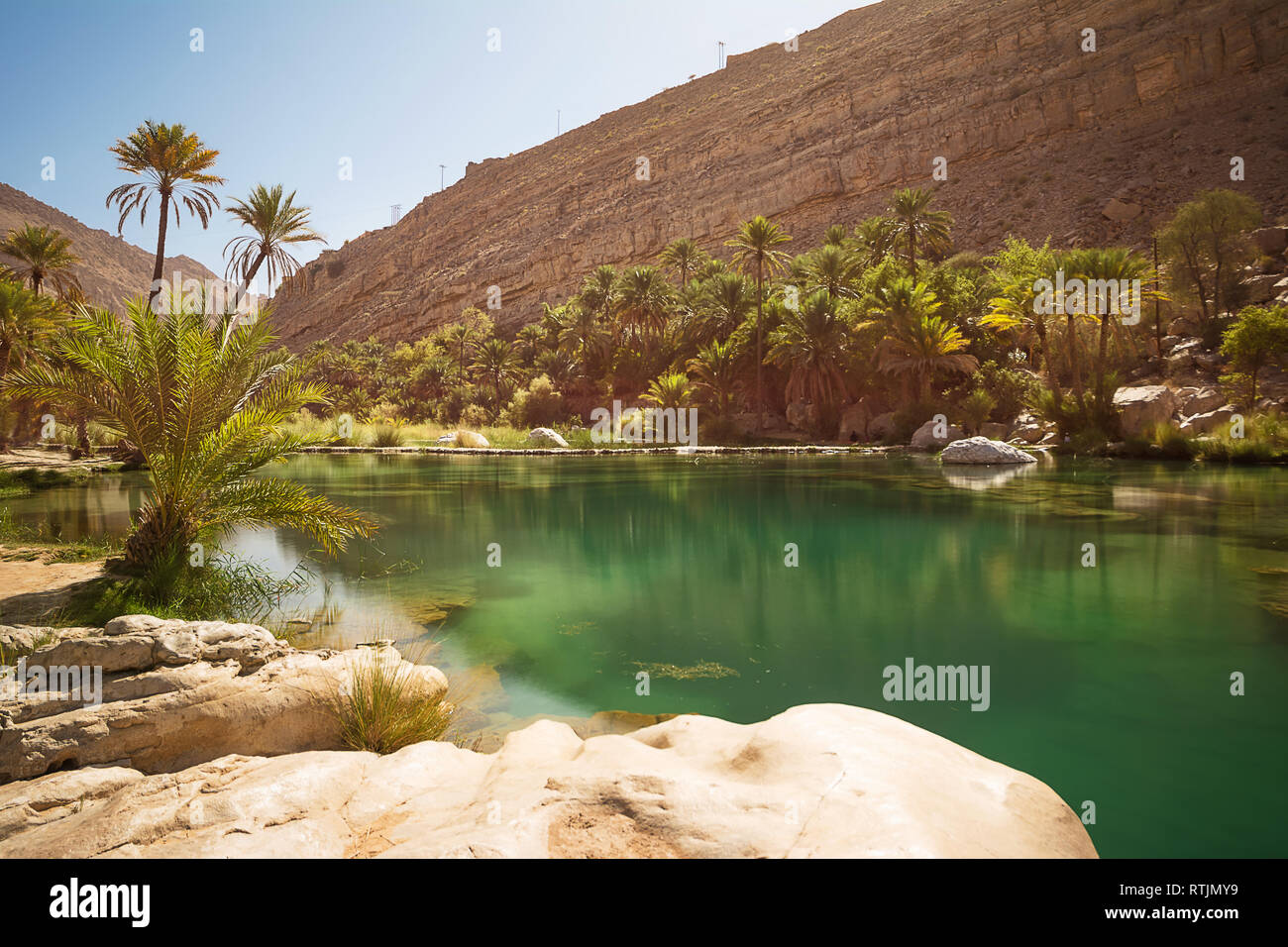 Amazing Lake and oasis with palm trees (Wadi Bani Khalid) in the Omani desert Stock Photo