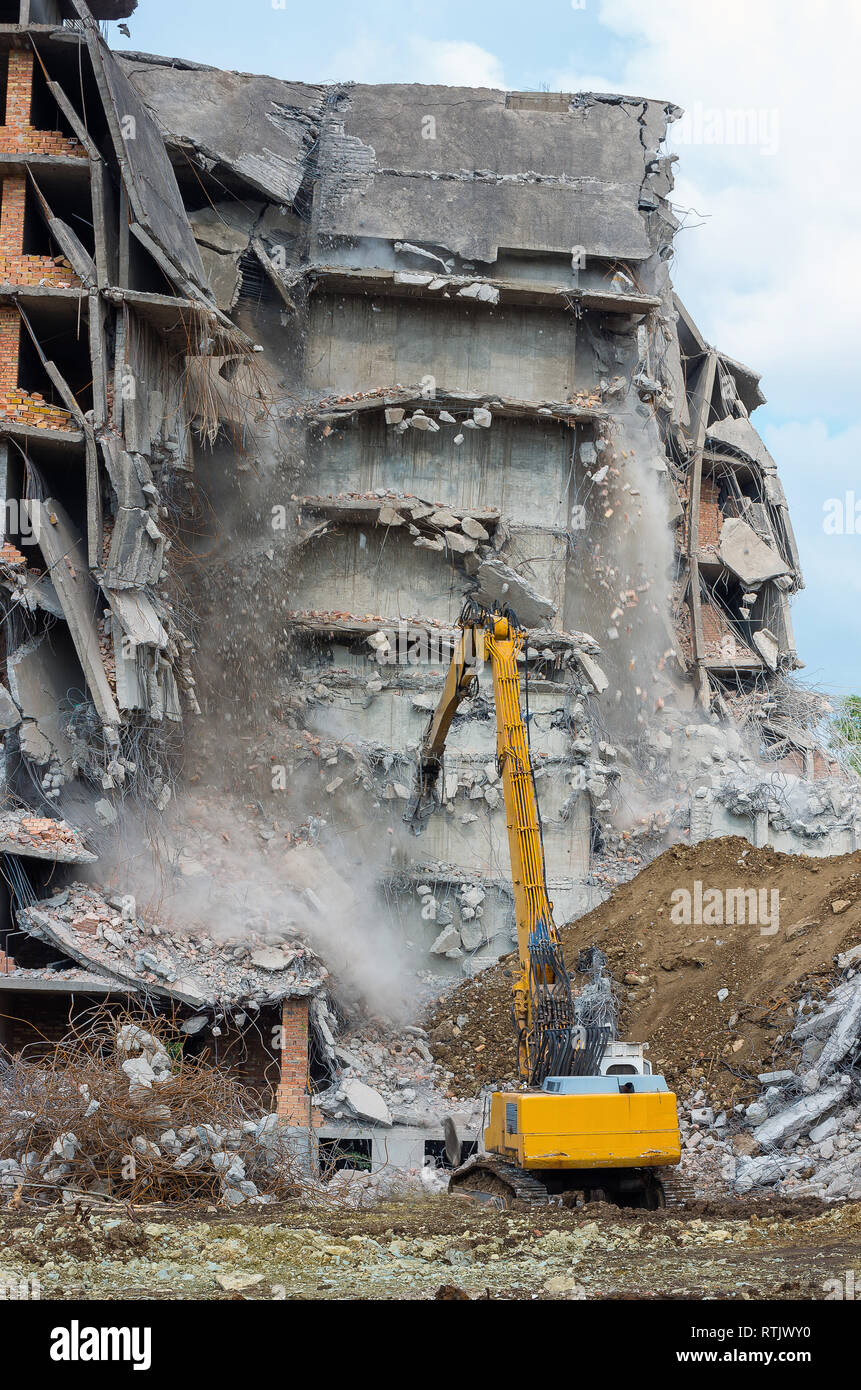 Building demolition with hydraulic excavator Stock Photo