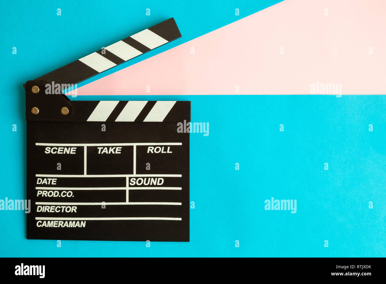 Clapper board on blue background minimal movie making and cinema film industry creative concept. Stock Photo