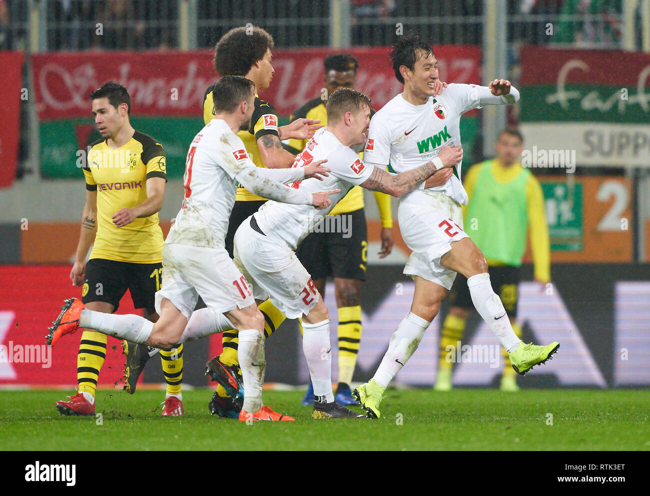 Augsburg, Germany. 01st Mar, 2019. Dong-Won JI, FCA 22 celebrates his goal for 2-0, happy, laugh, celebration, Ja-Cheol KOO, FCA 19 Daniel BAIER, FCA 10 Andre HAHN, FCA 28 Cheering, joy, emotions, celebrating, laughing, cheering, rejoice, tearing up the arms, clenching the fist, celebrate, celebration, Axel WITSEL, BVB 28 FC AUGSBURG - BORUSSIA DORTMUND 2-1 - DFL REGULATIONS PROHIBIT ANY USE OF PHOTOGRAPHS as IMAGE SEQUENCES and/or QUASI-VIDEO - 1.German Soccer League, Augsburg, March 1, 2019 Season 2018/2019, matchday 24, BVB, Bavaria Credit: Peter Schatz/Alamy Live News Stock Photo