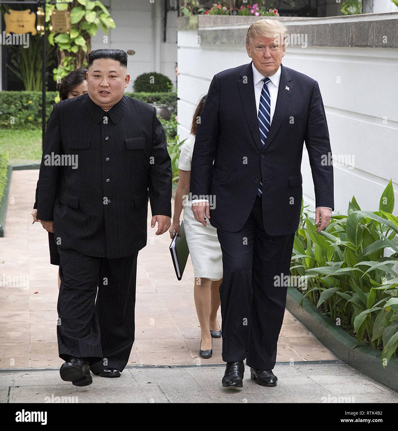 President Donald J. Trump and Kim Jong Un, Chairman of the State Affairs Commission of the Democratic People’s Republic of Korea, walk together on the pool patio Thursday, Feb. 28, 2019, at the Sofitel Legend Metropole hotel in Hanoi, prior to participating in an expanded bilateral meeting.   People:  President Donald Trump, Kim Jong Un Stock Photo