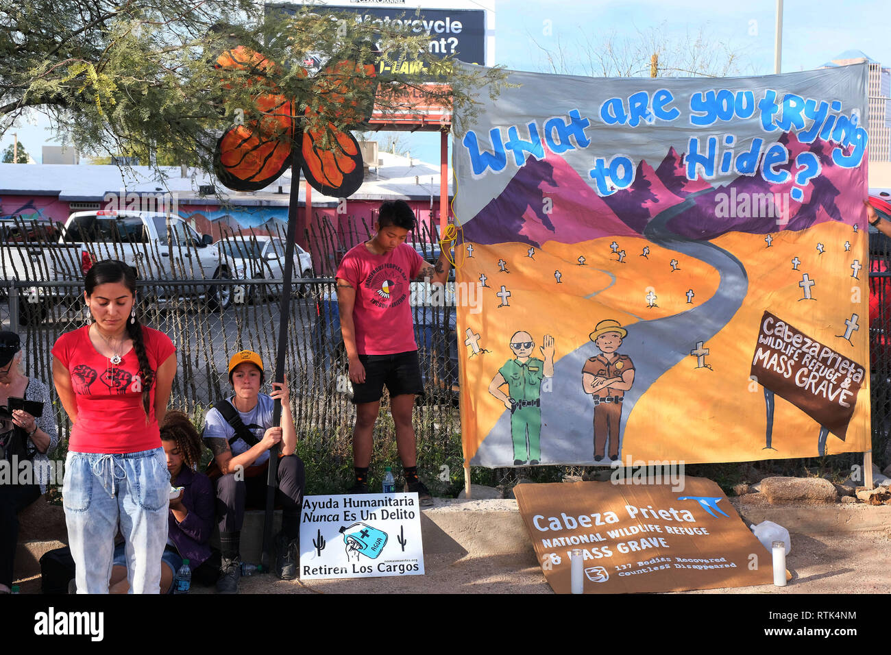 Tucson, Arizona, USA. 1st Mar, 2019. March 1, 2019- Members of No More Deaths hold vigil in Tucson after the sentencing in Federal Court of 4 members of the group who left water on Federal lands for migrants who crossed the border illegally into Arizona. They were arrested for trespassing and found guilty of misdemeanor charges. They didn't receive jail time but instead got probation and ordered to pay a fine. The group held a march through Tucson and carried symbolic water jugs similar to the ones they left in the wildlife refuge. They later lit candles to honor migrants who had died cros Stock Photo