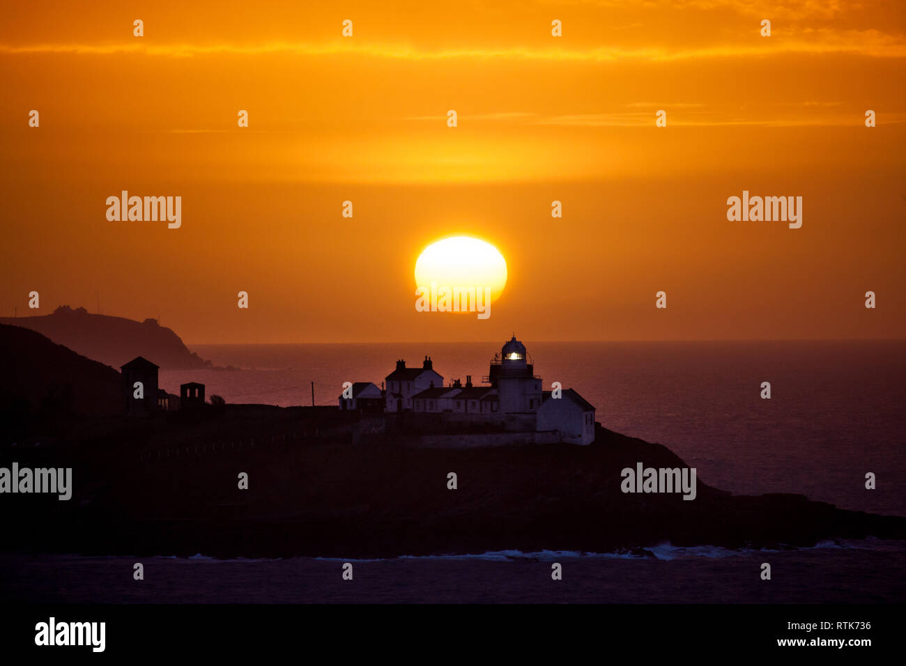 Roches Point, Cork, Ireland. 02nd March, 2019. A glorious sunrise over the Roches Point Lighthouse in Cork Harbour, Ireland and would give way to rain which turned heavy and persistent at times. The rain will be accompanied by a strong southerly wind, which will be stronger at the west coast and high seas will bring the risk of coastal flooding. Credit: David Creedon/Alamy Live News Stock Photo