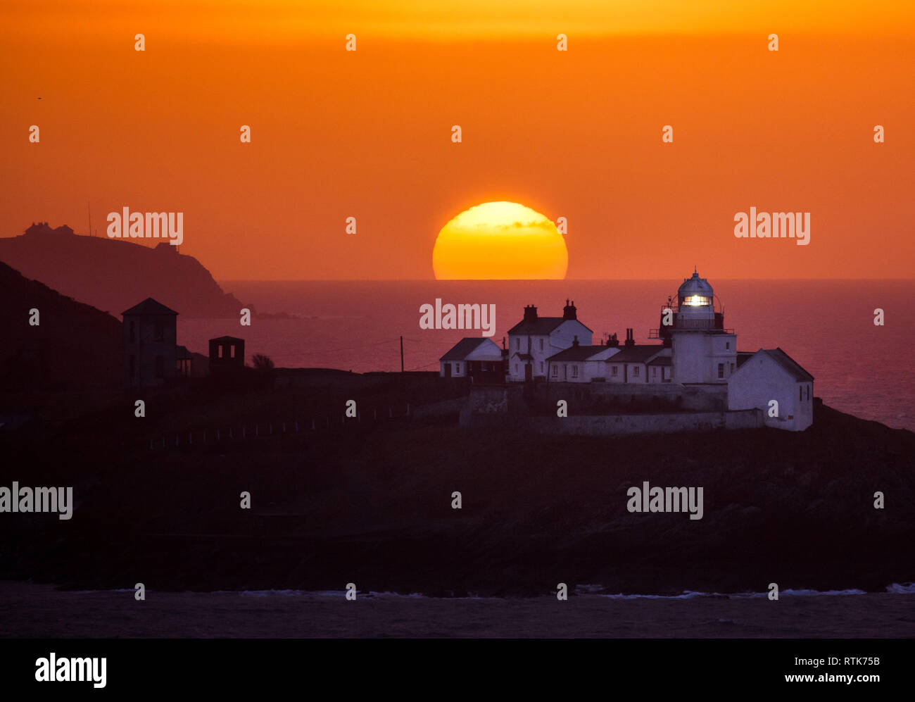 Roches Point, Cork, Ireland. 02nd March, 2019. A glorious sunrise over the Roches Point Lighthouse in Cork Harbour, Ireland and would give way to rain which turned heavy and persistent at times. The rain will be accompanied by a strong southerly wind, which will be stronger at the west coast and high seas will bring the risk of coastal flooding. Credit: David Creedon/Alamy Live News Stock Photo