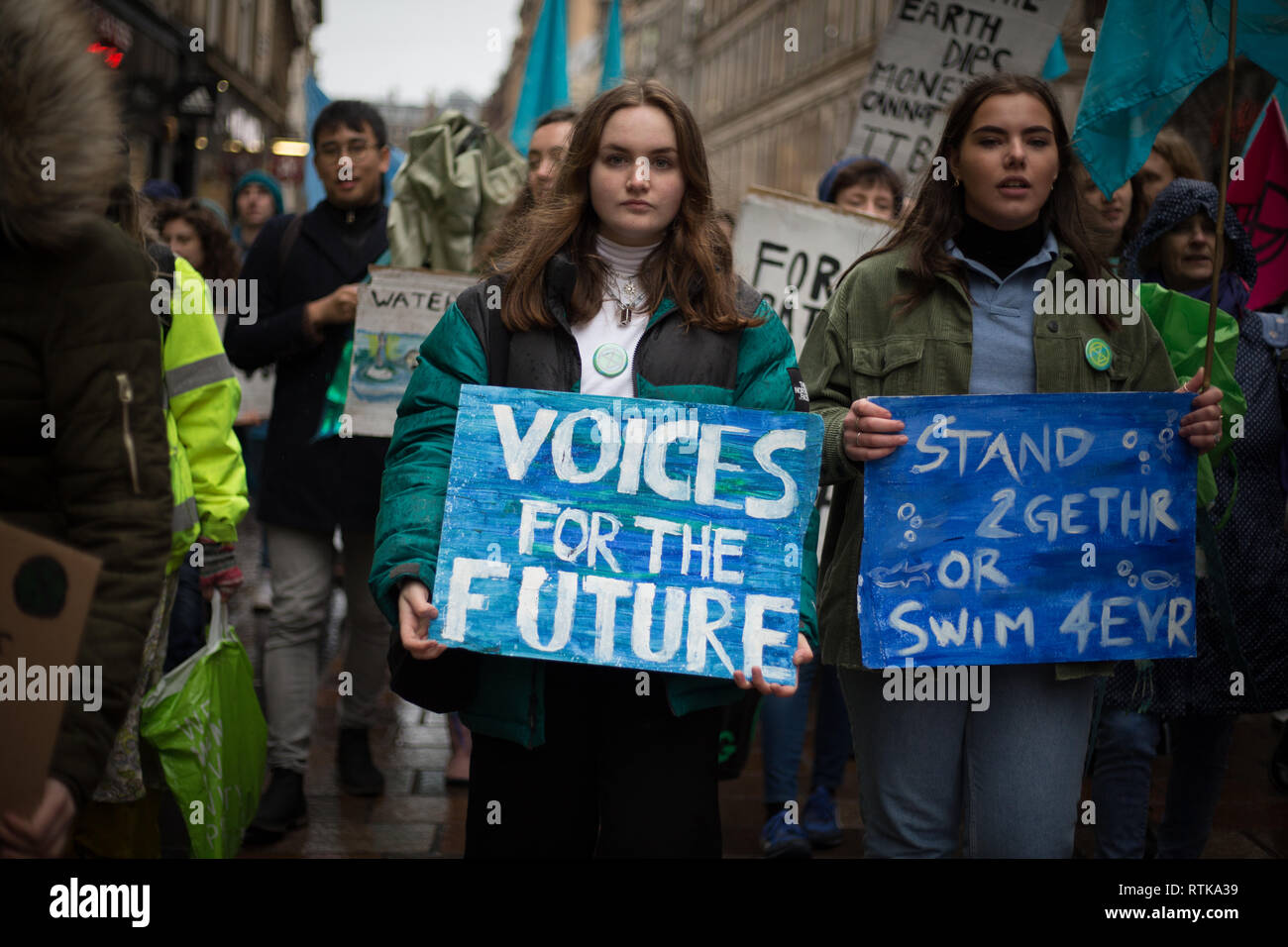 Glasgow, Scotland, 2 March 2019. The 'Blue Wave' demonstration by the Extinction Rebellion climate change group and supporters, blocking roads and moving through the streets of the city to highlight the rising waters of the River Clyde and to warn of the dangers of climate change if urgent action isn't taken immediately. The peaceful demonstration of approximately 200 people culminated with the symbolic throwing of water from the River Clyde on to the City Chambers steps, a symbol of the water levels to come. In Glasgow, Scotland. Credit: Jeremy Sutton-Hibbert/Alamy Live News. Stock Photo