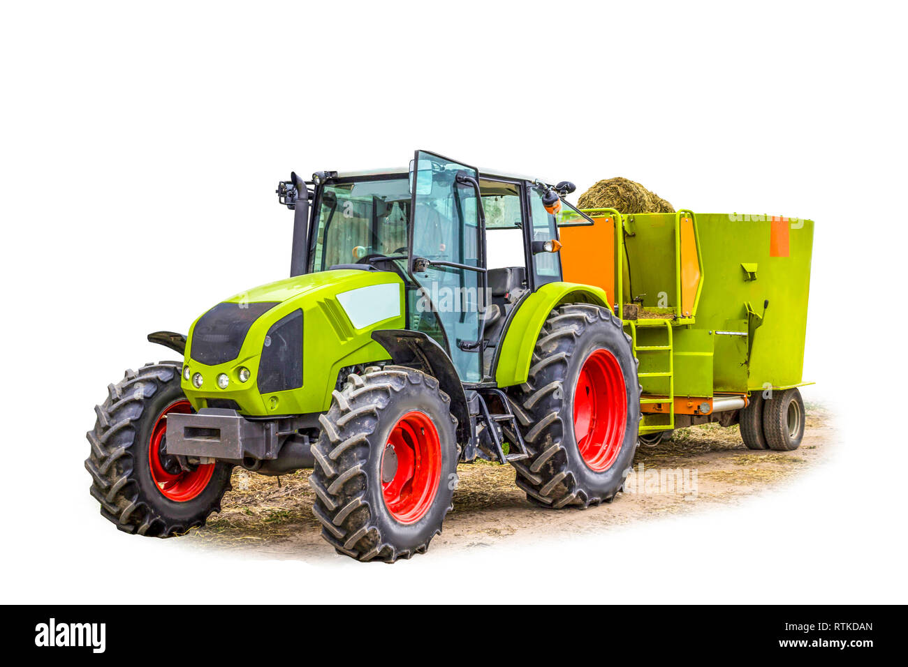 Tractor with a trailer for mixing and distribution of feed for cows. Isolated photo. Necessary equipment for a dairy farm. Stock Photo