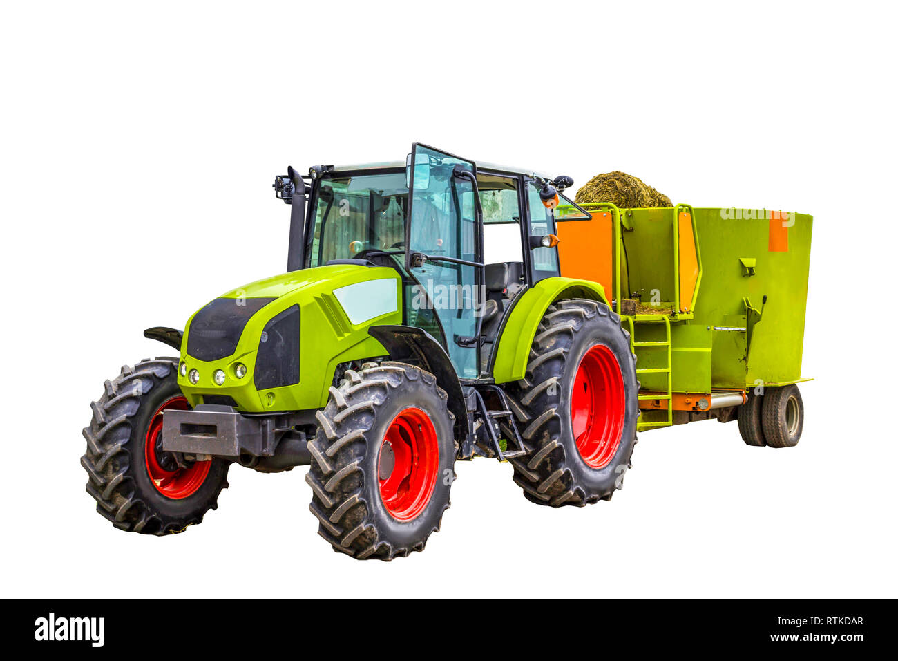 Tractor with a trailer for mixing and distribution of feed for cows. Isolated photo. Necessary equipment for a dairy farm. Stock Photo