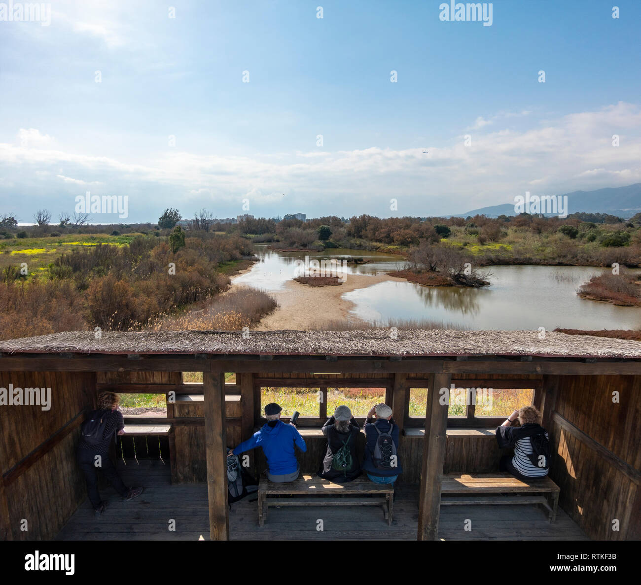 Birdwatchers Birdwatching British tourists expats Bird watching from hide Guadalhorce River Estuary Natural Area Malaga Costa del Sol Spain in winter Stock Photo