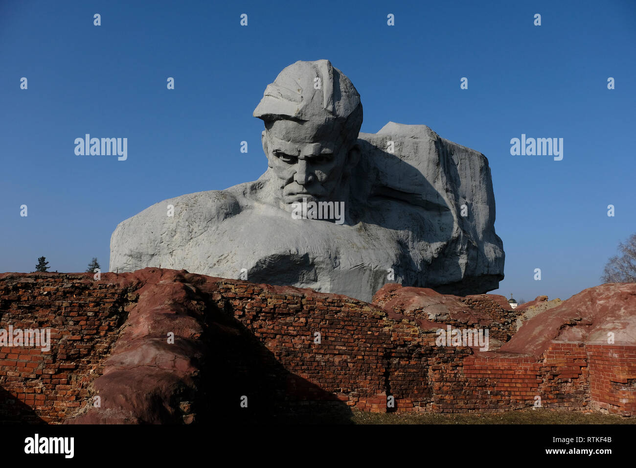 View of the gigantic sculptural image of a Soviet combatant in front of a banner commonly known as 'Courage' at the war memorial complex 'Brest Hero Fortress' located in Brest fortress formerly known as Brest-Litovsk Fortress, a 19th-century Russian fortress in the city of Brest, Belarus Stock Photo