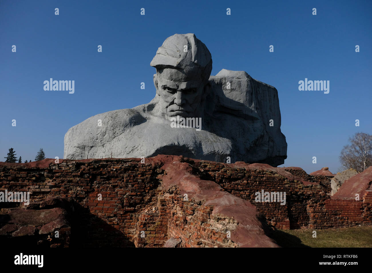 View of the gigantic sculptural image of a Soviet combatant in front of a banner commonly known as 'Courage' at the war memorial complex 'Brest Hero Fortress' located in Brest fortress formerly known as Brest-Litovsk Fortress, a 19th-century Russian fortress in the city of Brest, Belarus Stock Photo